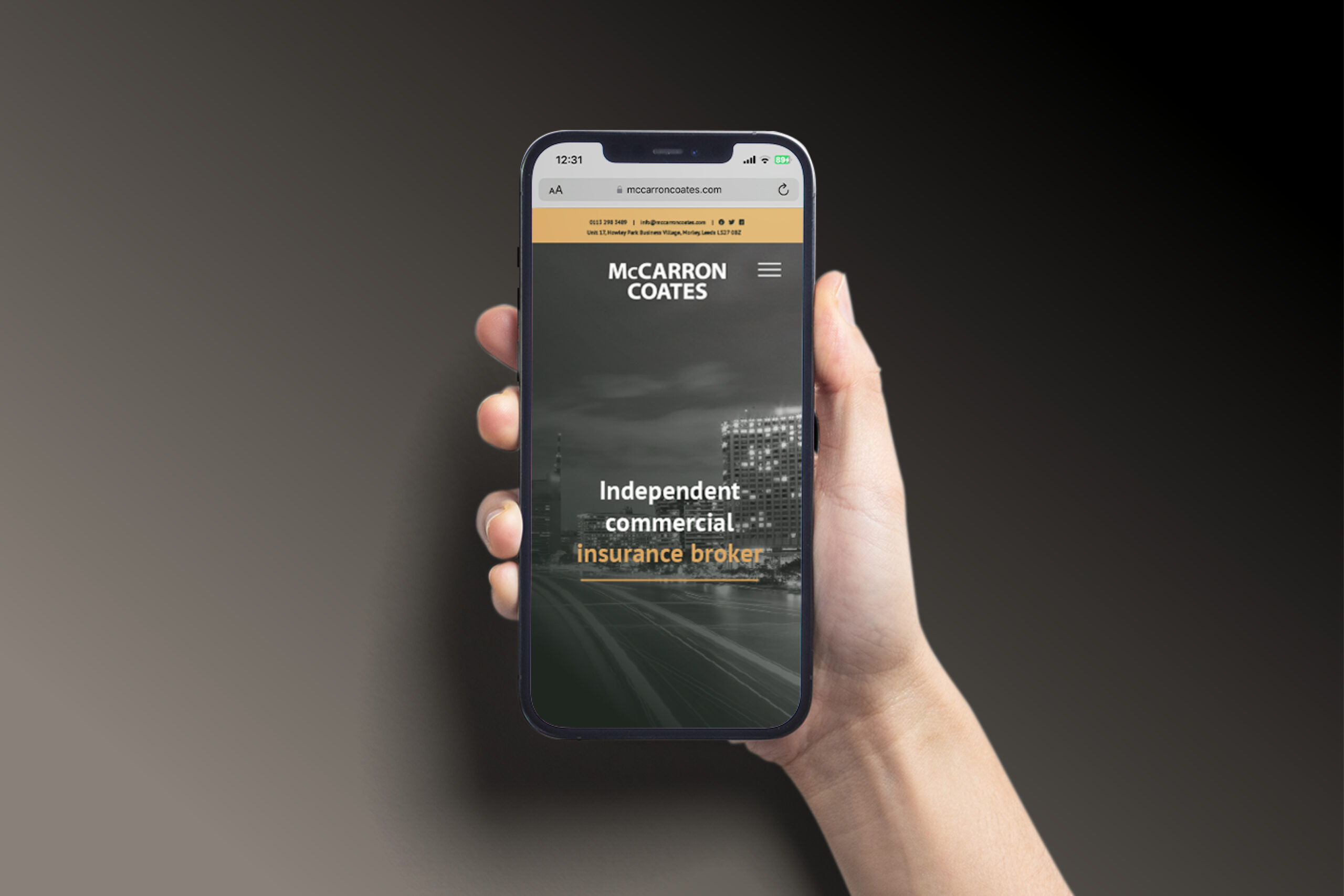 McCarron Coates insurance website on a mobile phone in a woman's hand