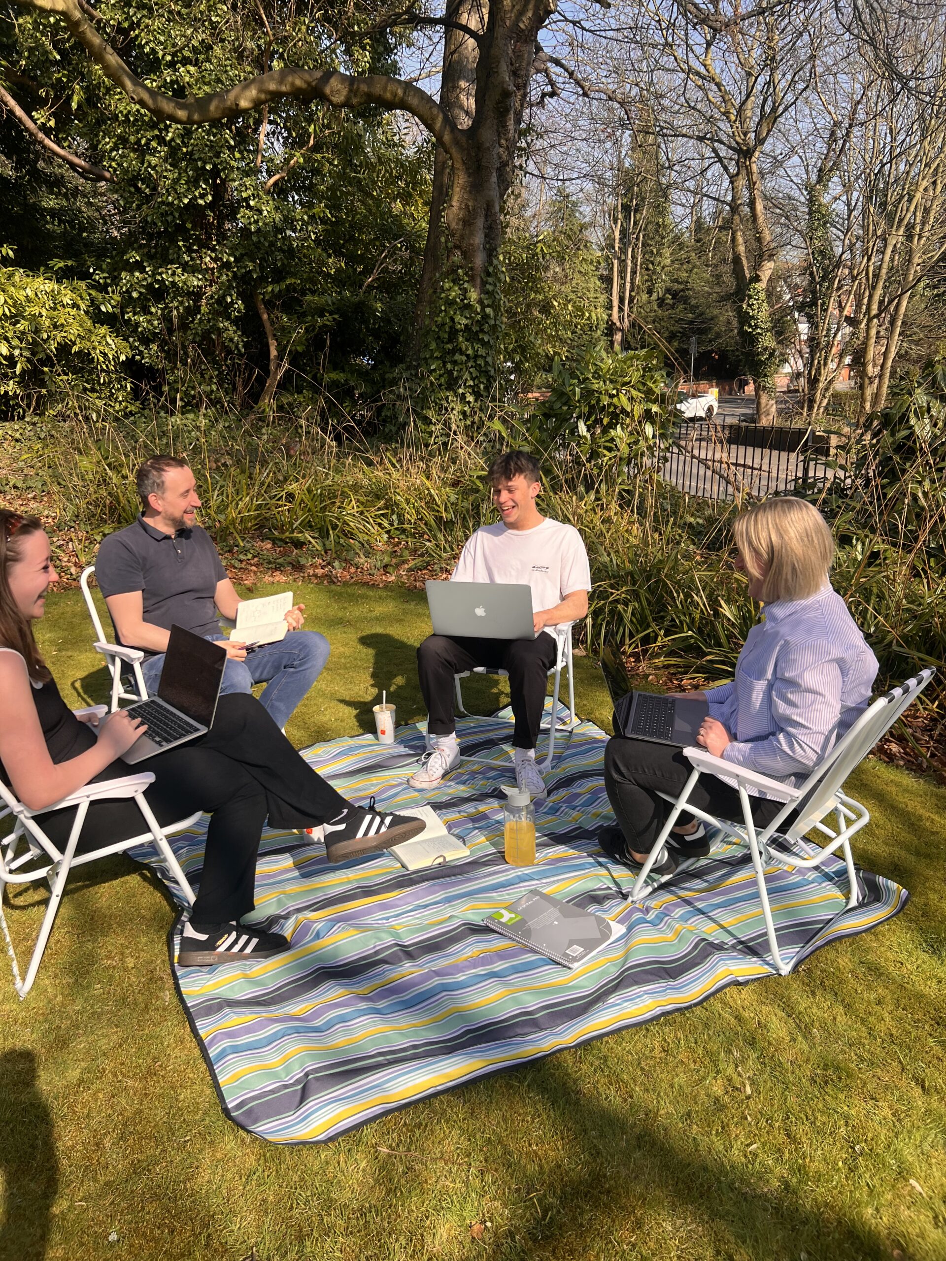 marketing team with laptops outdoors
